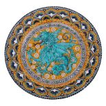 An Italian majolica charger by C Norelli decorated in bright enamels with a dragon medallion within