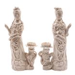 A pair of Chinese blanc de chine figures of Guanyin each wearing jewelled robes and holding a ruyi
