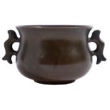 A small Chinese bronze censer of bombe form with flattened loop handles,