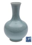 A Chinese bottle vase the pale greenish-blue glaze decorated with stiff plantain leaves,