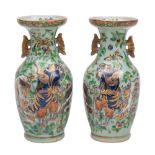 A pair of Canton baluster vases each moulded in low relief with the Immortal Li Tieguai carrying a