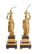 A pair of gilt brass figural lamps modelled as neo-classical females dressed in robes supporting