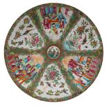 A Canton charger with small central bird and flower medallion within six fan-shaped panels,