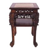 A Chinese carved and stained hardwood and marble mounted stand,