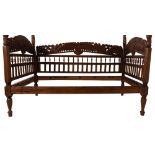 A south east Asian carved and stained wood day bed, in 17th century colonial style,