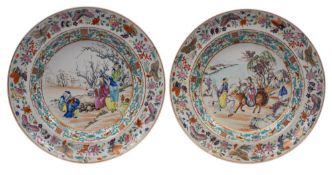 A pair of Canton plates finely enamelled, one with a scholar, attendants, a crane and plum trees,