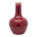 A Chinese flambé bottle vase the rich ox-blood glaze turning darker at the neck and falling short