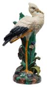 A Joseph Holdcroft majolica stick stand in the form of a stork with bullrushes and iris growing