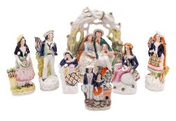 Seven Staffordshire pottery figures, comprising an arbour group, a pair of a sailor and his lass,