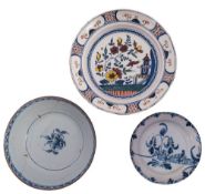 Three pieces of 18th century English delftware comprising a polychrome charger painted in the