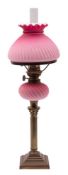 A Burmese pink ribbed glass and brass columnar oil lamp, early 20th century,