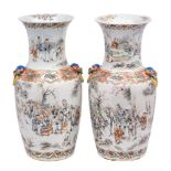 A pair of Chinese famille rose vases of baluster form with waisted necks and Buddhist lion mask