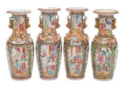 A pair of Canton baluster vases and a similar pair both with applied gilt lion dog handles and