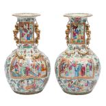 A pair of Canton baluster vases with shaped turnover rims and gilt lion dog and puppy handles,