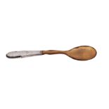 A Georg Jensen silver and horn beaded pattern spoon, assay master Christian F.