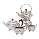 An Edward VII silver matched four piece tea service, makers Walker and Hall,