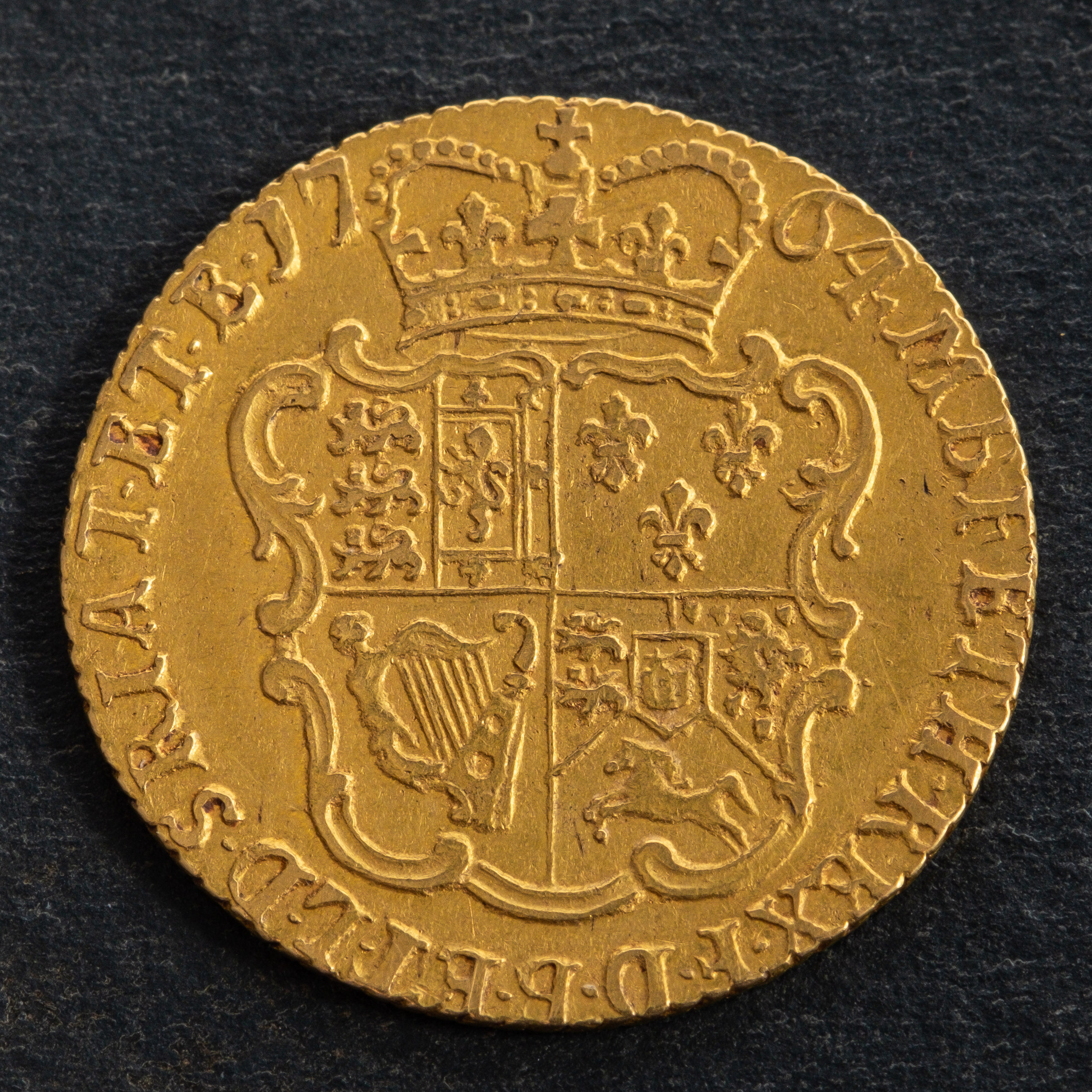 A George III Sovereign coin, dated 1704, diameter ca. 20.5mms, total weight ca. 4.1gms.