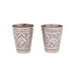 Two Persian silver tots of cylindrical tapering outline, with chased foliate decoration, 4.