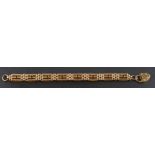 A 1970's, 9ct gold, garnet set, gate-link bracelet with heart-shaped clasp,