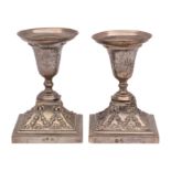A pair of Portuguese silver desk candlesticks: the urn-shaped sconces with garland decoration,