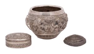 An Indian / Burmese rice bowl with embossed decoration of figures in a landscape with tapering