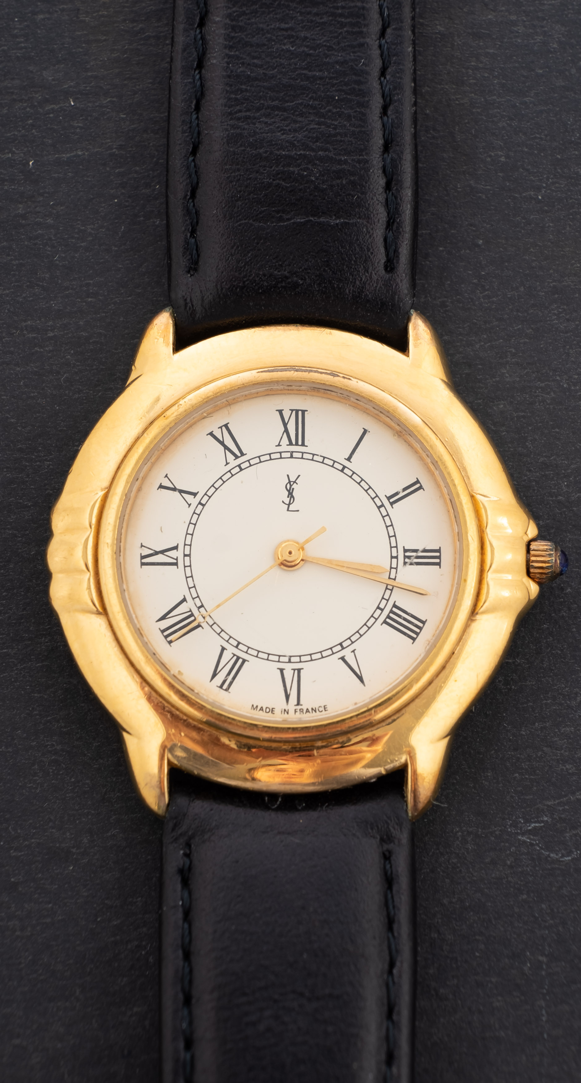 A gold-plated ladies quartz wristwatch signed YSL, for Yves Saint Laurent, on a leather strap,