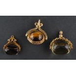 Three swivel fobs, including a 9ct gold, smokey quartz fob; a 9ct gold,