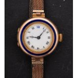 A 9ct gold ladies watch with blue enamelled circle to bezel the dial with black Roman numerals,