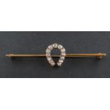 An old-cut diamond horseshoe brooch, total estimated diamond weight ca. 0.60ct, total length ca. 6.