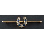 A mixed-cut sapphire and cushion-cut diamond horseshoe brooch, total estimated diamond weight ca. 0.