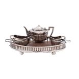 An Edward VII silver miniature three-piece tea service on an oval galleried twin-handled tray,
