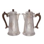 A pair of George V silver hot water jugs, makers Crichton Brothers,
