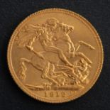 A George V sovereign coin, dated 1912, diameter ca. 22mms, total weight ca. 7.9gms.