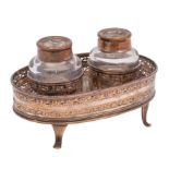 A late 18th Century silver plated ink stand of oval outline with galleried sides,