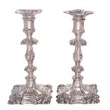 A pair of plated candlesticks in the George II taste with anthemion decoration and knopped stems,