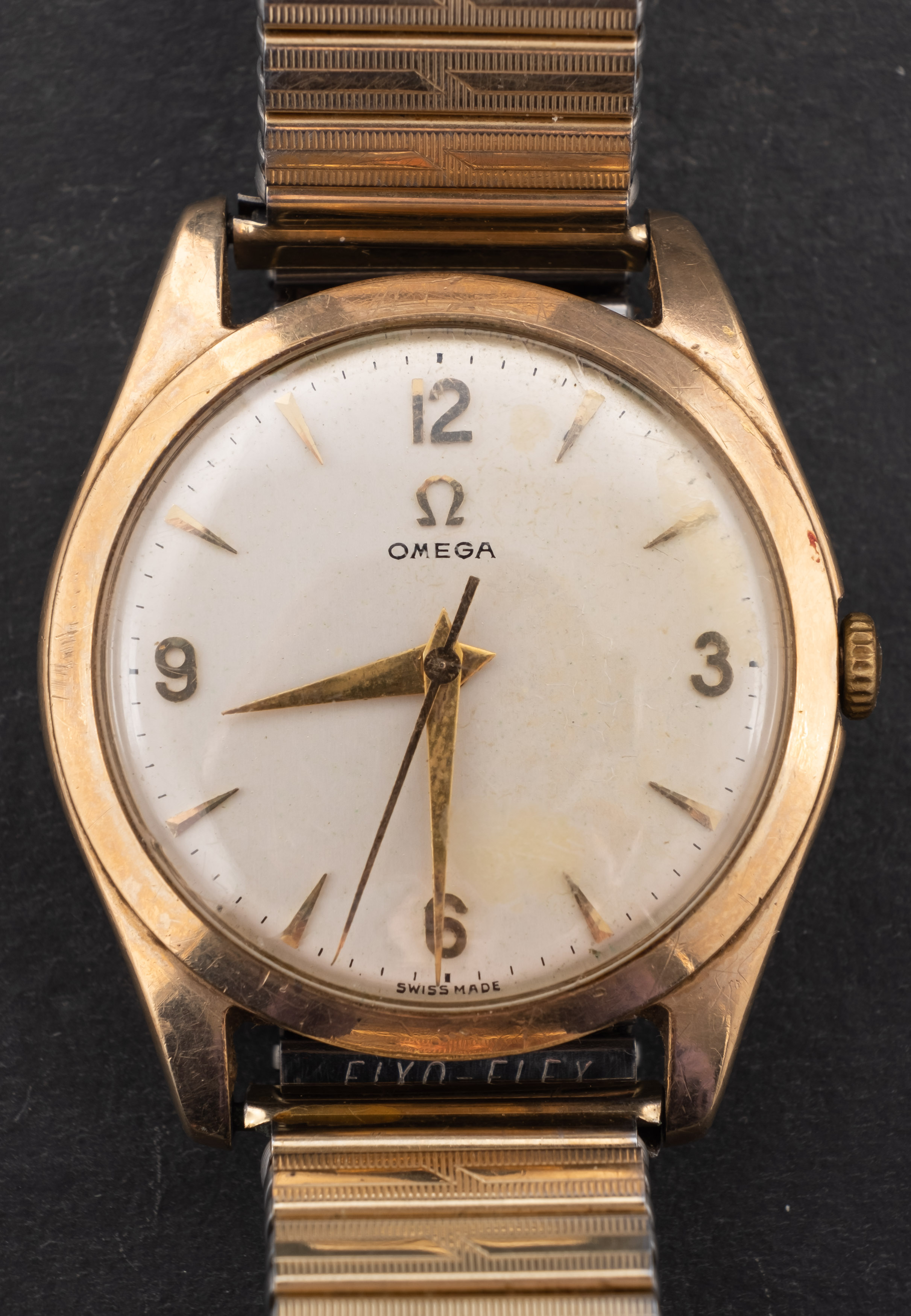 Omega, a gentleman's gold wristwatch the round cream dial with raised baton and Arabic numerals,