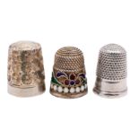 A Russian silver gilt and cloisonne enamel thimble with stylised decoration in blue, green,