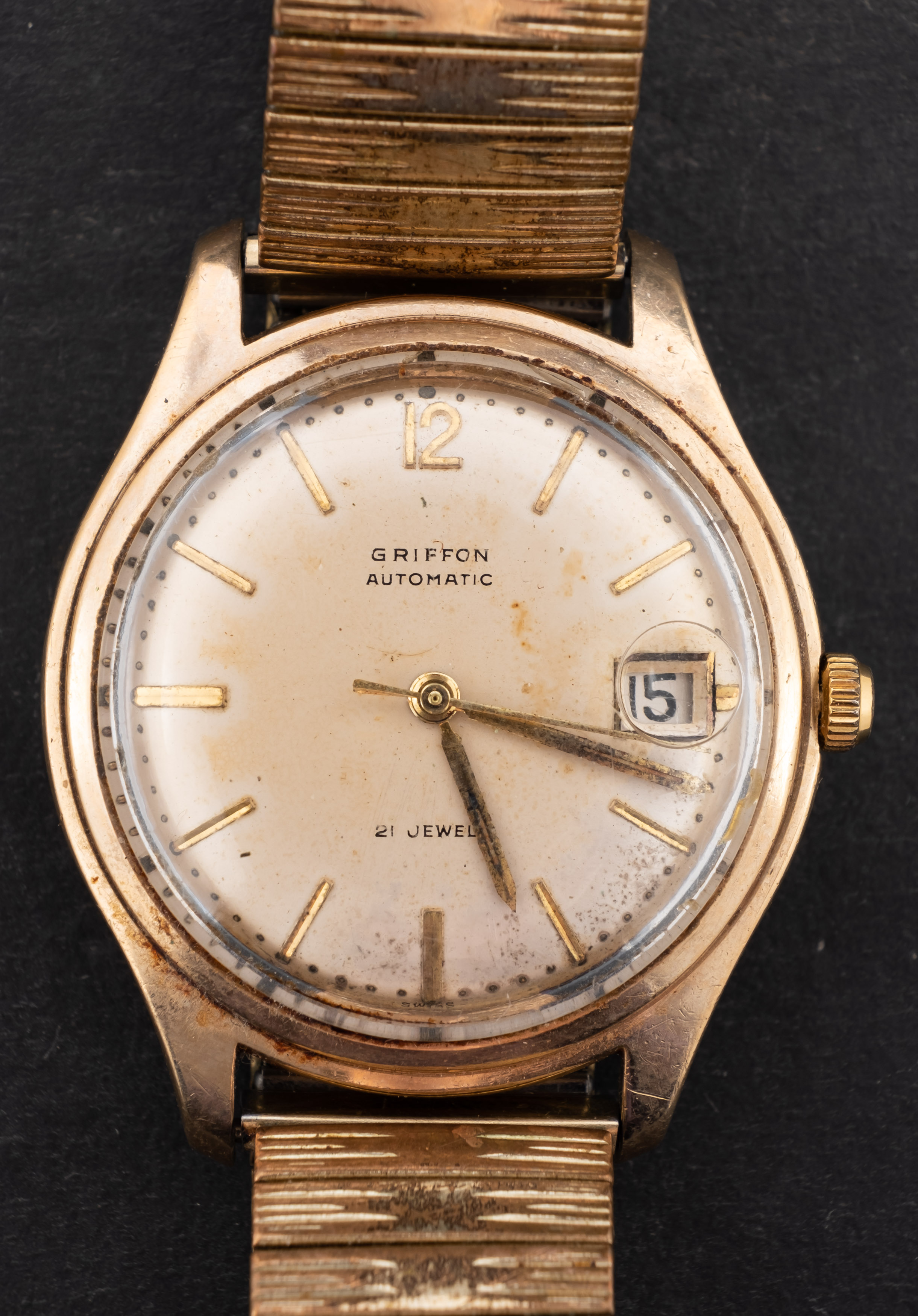 Griffon, a gentleman's gold wristwatch the champagne dial with raised baton numerals and Arabic 12,