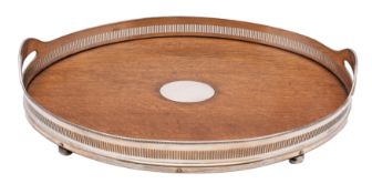 An Edwardian oak and plated oval galleried twin-handled tea tray on four bun feet, 51cm long.