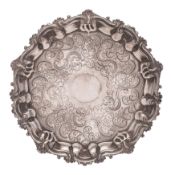 A Sheffield Plate salver, with engraved foliate and scroll decoration, raised on three swept feet,