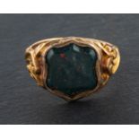 An Edwardian bloodstone signet ring, with foliate engraved shoulders, stamped '18CT',