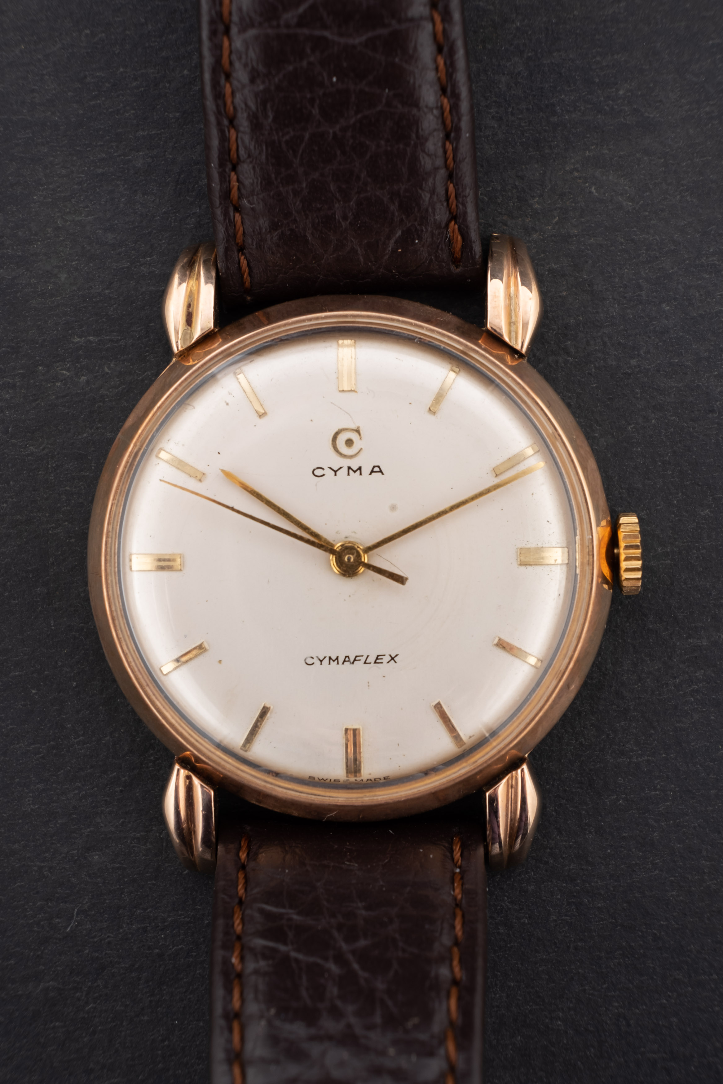 Cyma, Cymaflex, a gentleman's 9ct gold wristwatch the round cream dial with raised baton numerals,