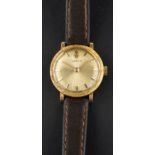 Corum, a dress wristwatch, the textured circular dial baton markers and hands,