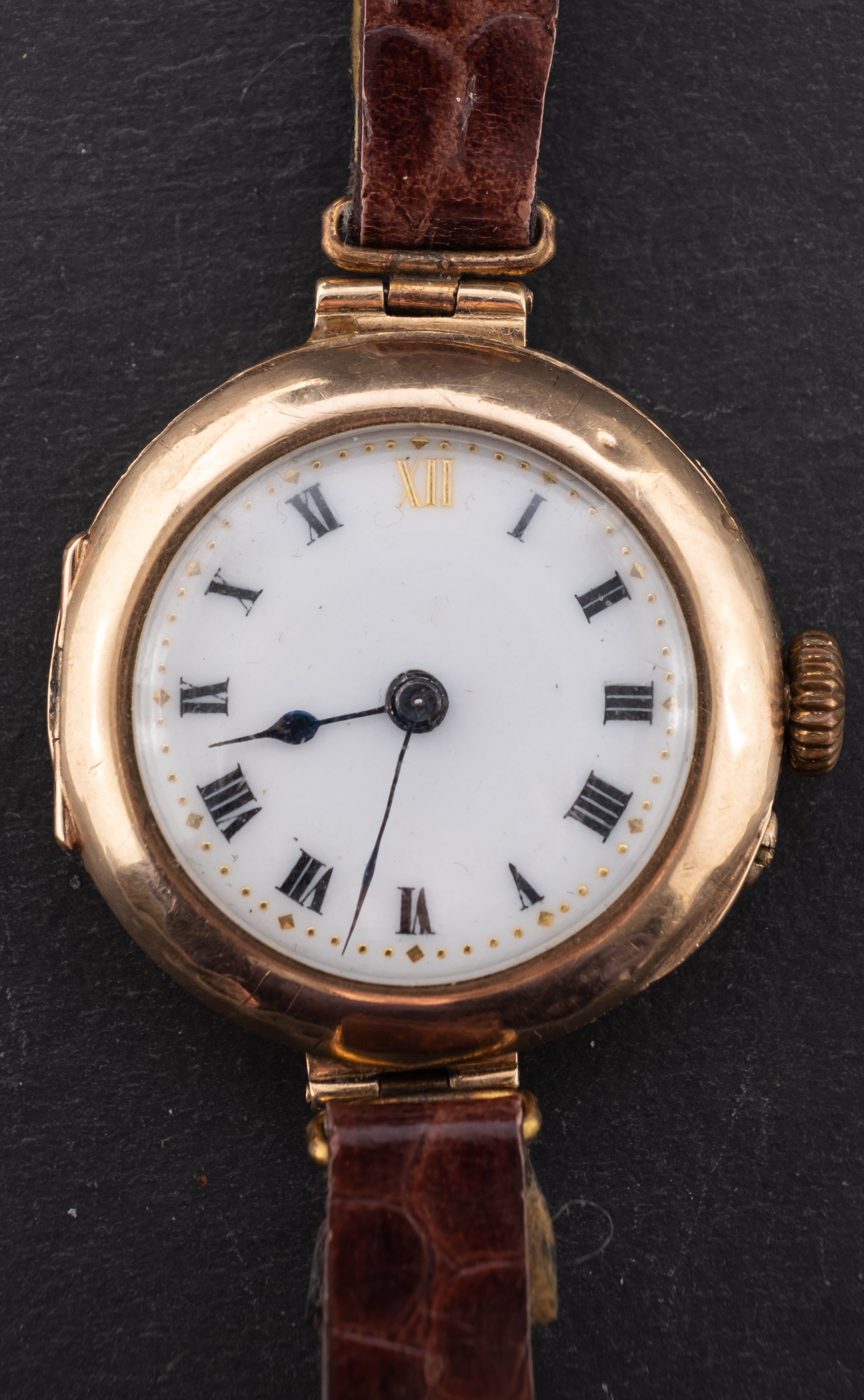 A 9ct gold ladies wristwatch the dial with black Roman numerals and spade hands,