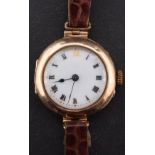 A 9ct gold ladies wristwatch the dial with black Roman numerals and spade hands,