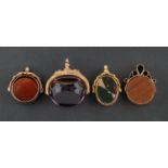 Four swivel fobs, including a 9ct gold, Edwardian, purple paste fob; a 9ct gold,