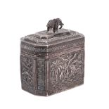 An Indian white metal lidded box of octagonal form with repousse decoration of a tiger near a