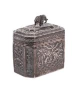 An Indian white metal lidded box of octagonal form with repousse decoration of a tiger near a