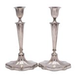 A pair of Edward VII silver candlesticks, makers Walker & Hall, Chester, date letters worn,