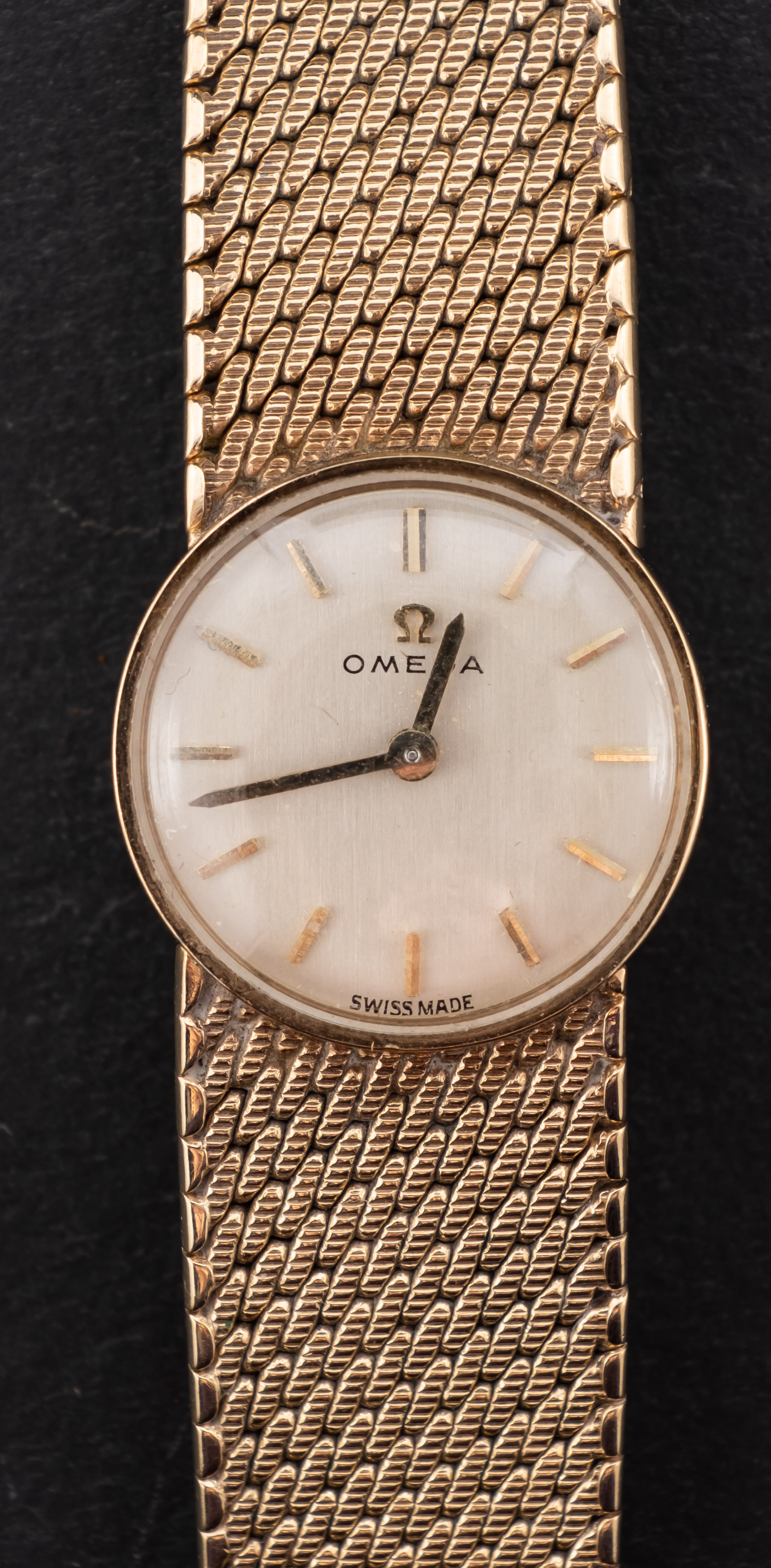 Omega, a ladies 9ct gold wristwatch the dial with raised baton numerals,